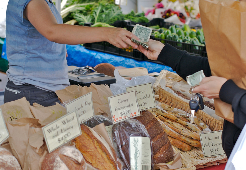Cash purchase of fresh bread at farmers market